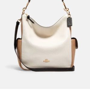 Coach Purse. Used one time. Beige color with outside pockets.  $130